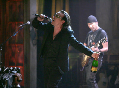 Bono sings with champagne