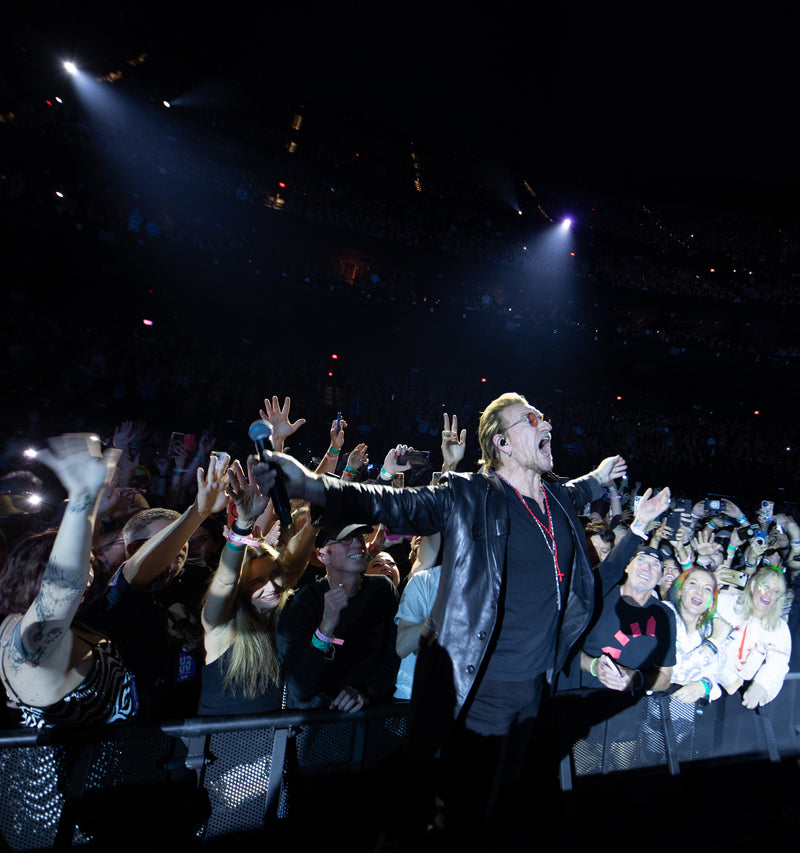 Bono held up by the audience..