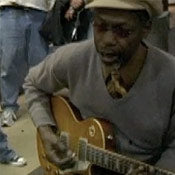 Edge and Walter Playing Guitar for Music Rising