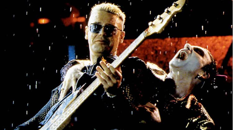 A gleaming gold-colored electric bass guitar with a sleek, modern design and glossy finish.