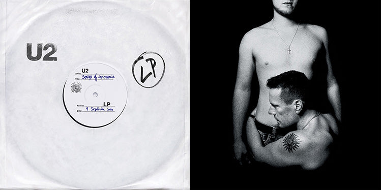 White u2 vinyl record with black text and a hand-drawn ’lp’ sticker on its sleeve.